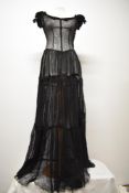 A striking Art Deco cotton tulle evening gown in black, having elasticated sleeves with velvet bow