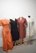 A collection of 1960s dresses and a jacket, including textured burnt orange maxi dress and black