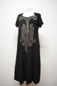 A late 1930s Art Deco black crepe dress, having extensive silver tone sequin and glass bead detail