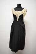 An unusual 1950s cream and black grosgrain party dress, having sequins and beading to bodice, half
