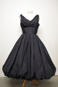 A really unusual navy blue taffeta 1950s gown, having full puff ball skirt, boned bodice and wide