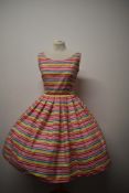 A bright and cheerful 1950s 'Calafornia Cottons' day dress, having scoop neckline, full pleated