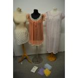 Three pairs of vintage pastel coloured stockings, two nylon nightdresses and a lace underskirt