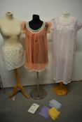 Three pairs of vintage pastel coloured stockings, two nylon nightdresses and a lace underskirt
