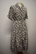 A 1940s floral day dress in a silky (most probably rayon) fabric, having buttons to front, a few