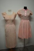 Two pale pink 1950s lace and taffeta dresses, one having satin Peter Pan collar and faux button