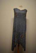A pale blue 1920s flapper dress, having extensive gold and silver sequin detail throughout and