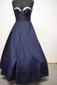 A 1950s full skirted navy blue watered taffeta strapless evening gown with silver satin banding to