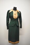 A 1930s/40s bottle green wool day dress, having peach modesty style panel and collar with bow