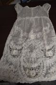 An antique child's tulle and lace gown.