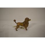 A late 19th/early 20th century cast metal novelty tape measure in the form of a poodle.