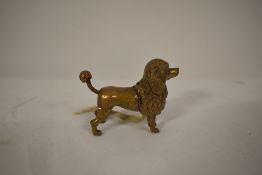 A late 19th/early 20th century cast metal novelty tape measure in the form of a poodle.