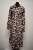 A 1940s floral cotton day dress, having button down front, large collar, dropped waist and pockets