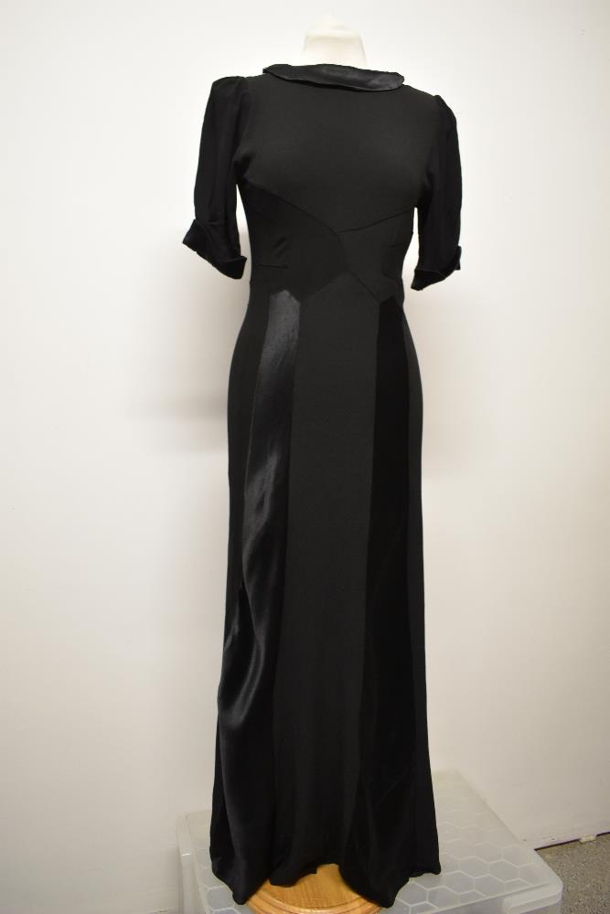 A stunning Art Deco 1930s evening gown of black satin backed crepe, with wonderful use being made of