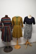 Three 1950s to 60s day dresses, including vibrant wool full skirted dress, and boucle wool skirted