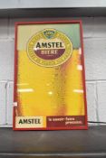 An illuminated sign, Amstel Biere Lager