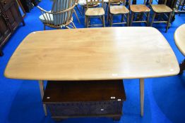 A vintage light Ercol dining table having splay legs, approx 150 x 77cm