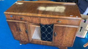 A 1950s walnut sideboard having central display section