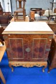 A vintage walnut TV or cocktail cabinet having marble top and gilt detailing