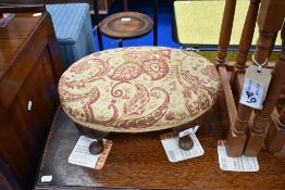 A vintage oval footstool