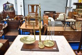 A Victorian brass balance scale on mahogany base , stamped Avery and Agate Patent, with selection of