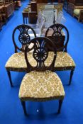 A set of three wheelback dining chairs