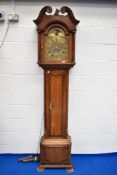 An oak long case clock having 8 day movement and brass moon phase dial, as found
