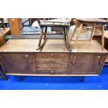 A vintage elm sideboard, probably Ercol having central four drawer section flanked by cupboards on