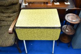 A vintage metal frame kitchen side table having formica top and drop leaves