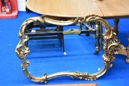A large gilt frame wall mirror of scroll and foliate design