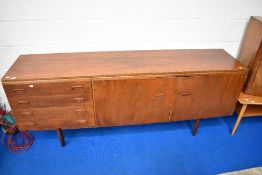 A 1970s vintage teak sideboard having double cupboard and four side drawers, approx dimensions