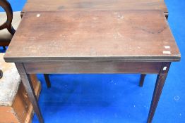 A 19th Century fold over tea table having inlaid square tapered legs