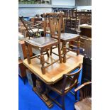 An early 20th Century oak drawer leaf dining table on bulbous frae and a set of four similar chairs