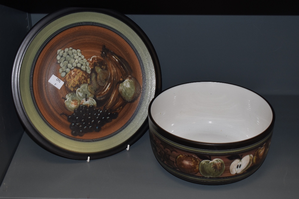 An Ambleside Pottery fruit bowl and plate, both having decoration of grapes, apples, pears and
