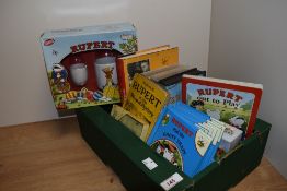 A selection of childrens books and videos, of Rupert bear interest.