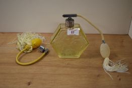 A mic century yellow glass perfume atomiser, having Art Nouveau styling depicting couple to front.
