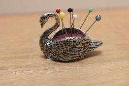 A 20th century silver tone pin cushion in the form of a swan.