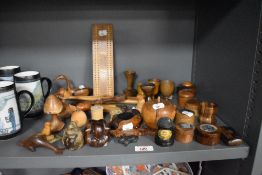 An assortment of treen, including carved wood studies, games board, snuff box, puzzle and animal