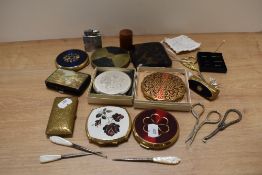 A selection of vintage compacts including Stratton, sewing scissors, carved Japanese cigarette