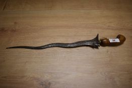 An Indonesian Kris dagger, having carved wood handle.