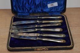 A set of hallmarked silver handled butter knives in box.