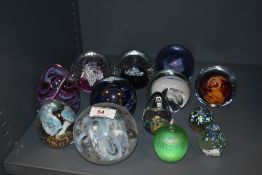 A collection of paperweights, including Mdina glass and Caithness.