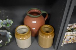 Two earthenware jars and a large terracotta jug.