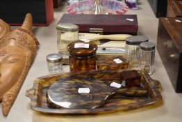 A selection of vintage dressing table items, including tortoiseshell effect mirror, tray and trinket