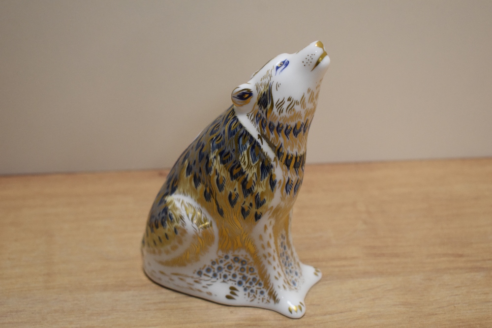 A Royal Crown Derby wolf paper weight, having gold stopper.