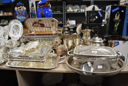 An assortment of flat ware and cutlery, including plated ware, serving dishes, goblets and