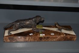 An Art Deco depiction of a red setter and pheasant, on marble base.