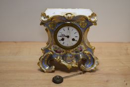 An early Victorian ceramic clock, having extensive gilt detailing with hand painted florals and