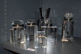 A collection of modern glass perfume bottles, having Art deco styling.