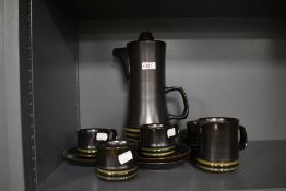 An attractive vintage ten piece studio pottery coffee set, in the manner or influenced by Denby